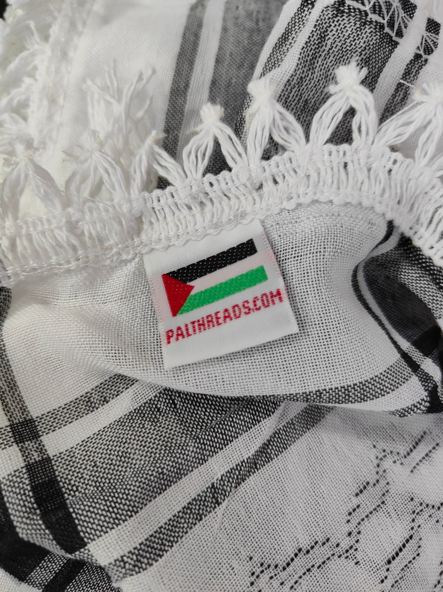 The traditional black and white keffiyeh is proudly made in Palestine and carries the original Palthreads.com label