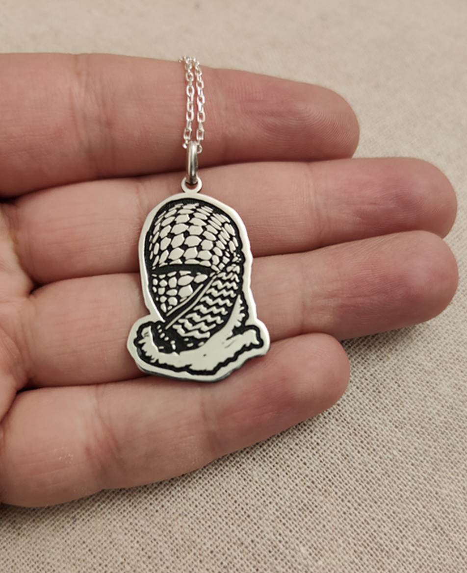 Face wrapped Palestine keffiyeh
