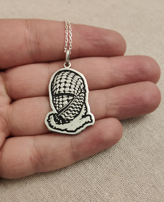 Face wrapped Palestine keffiyeh